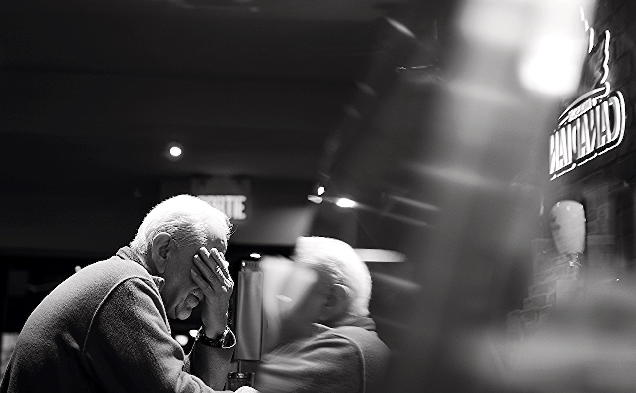 elderly holding his face