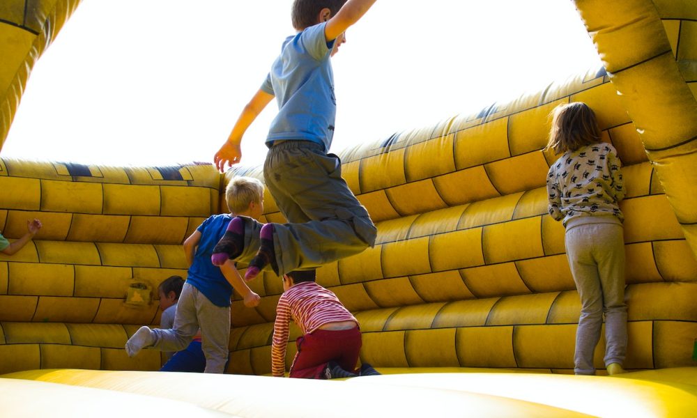 kids playing on inflatable castle