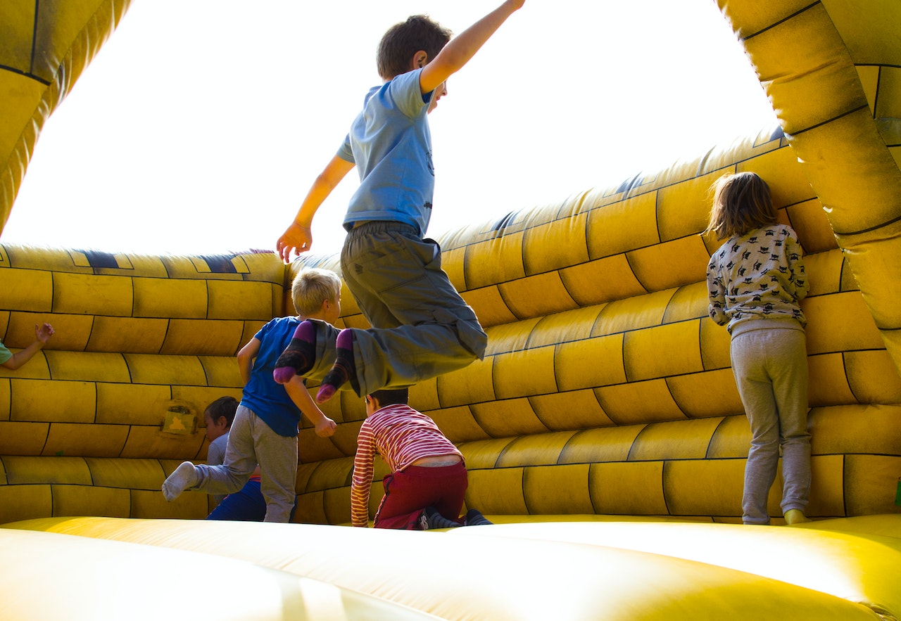 kids playing on inflatable castle