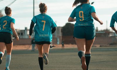 Three Women Wearing Blue Jersey Shirt Running