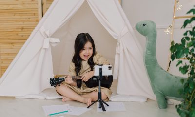 A Cute Girl Recording a Video while Playing Ukulele