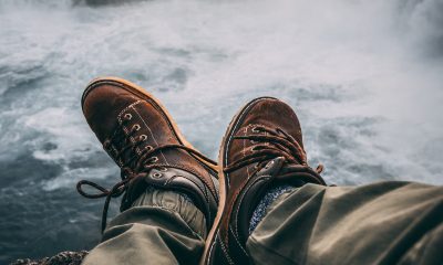 Person Sitting on Rock Near Waterfalls