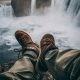 Person Sitting on Rock Near Waterfalls