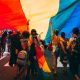 people under a huge pride flag