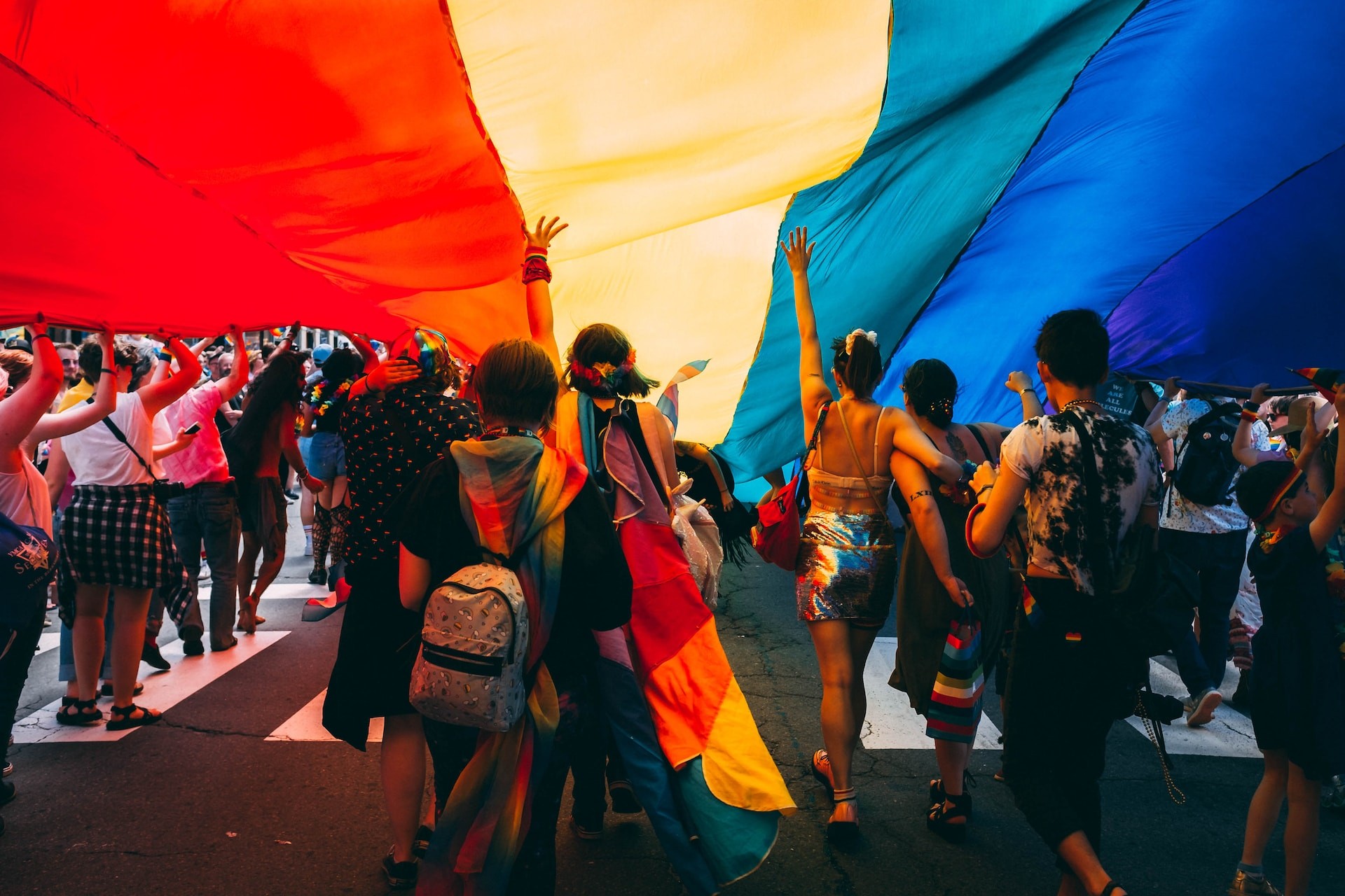 people under a huge pride flag