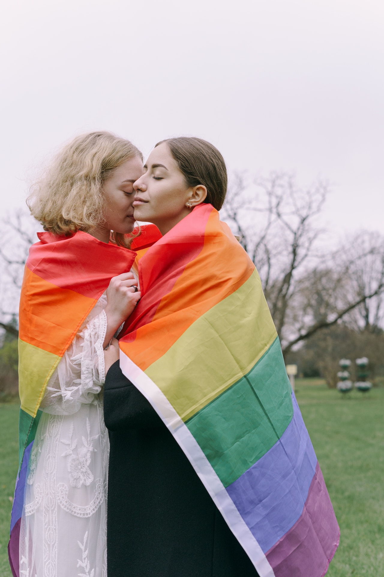 LGBT flag wrapped around sweet couple