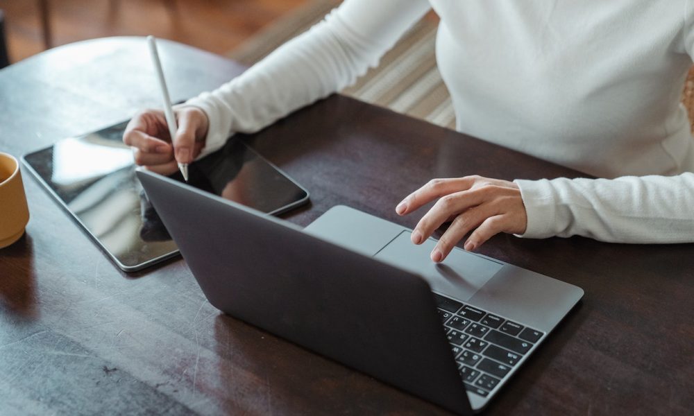 female hands working on laptop and ipad