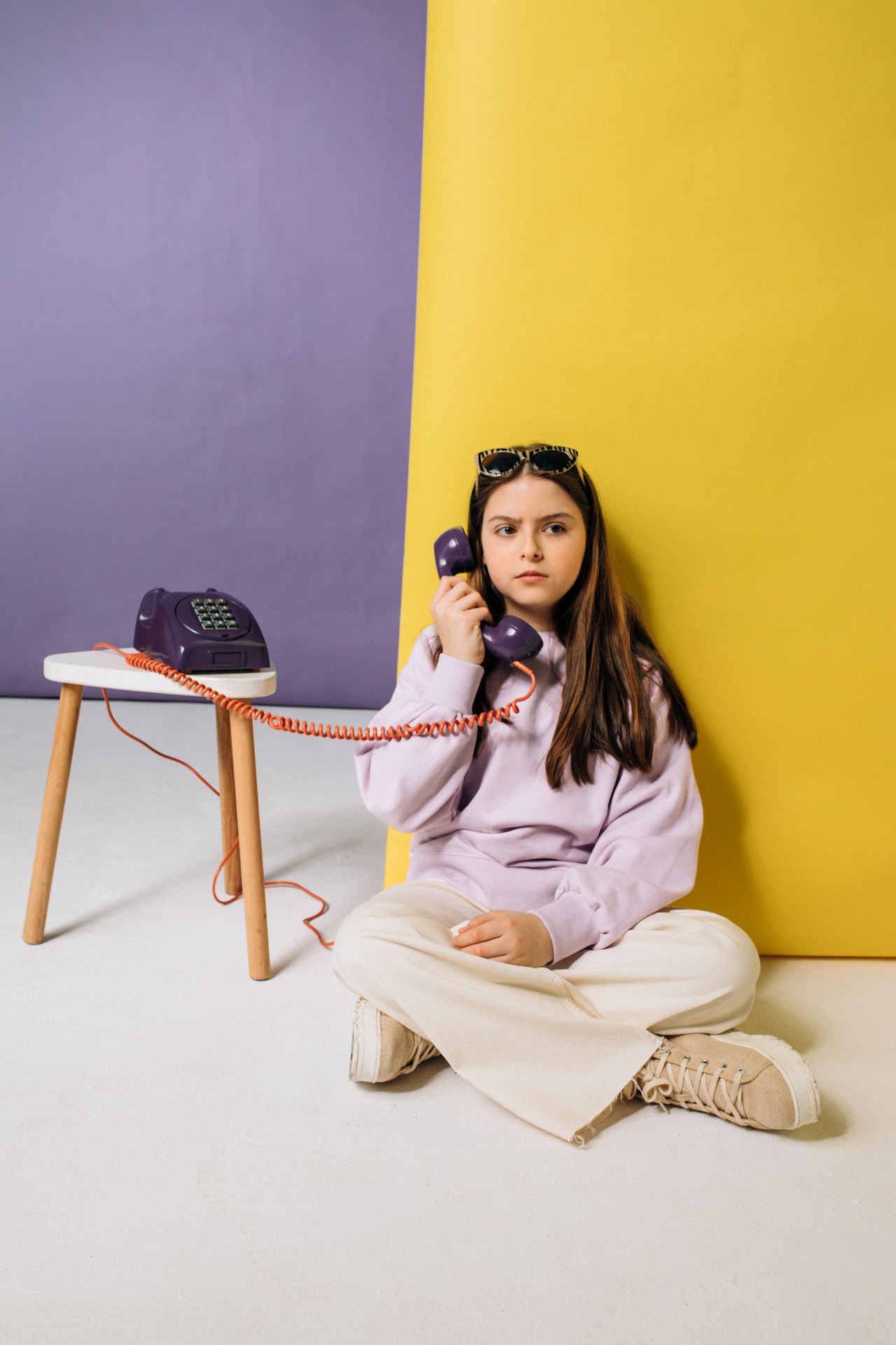 kid holding a telephone on her ear