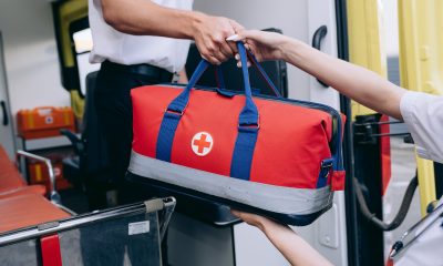 Person Holding Red and Black Sling Bag