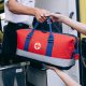 Person Holding Red and Black Sling Bag