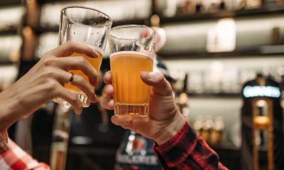 hands raising glasses of beer