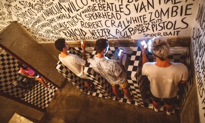 Group of people in public toilet using smartphones