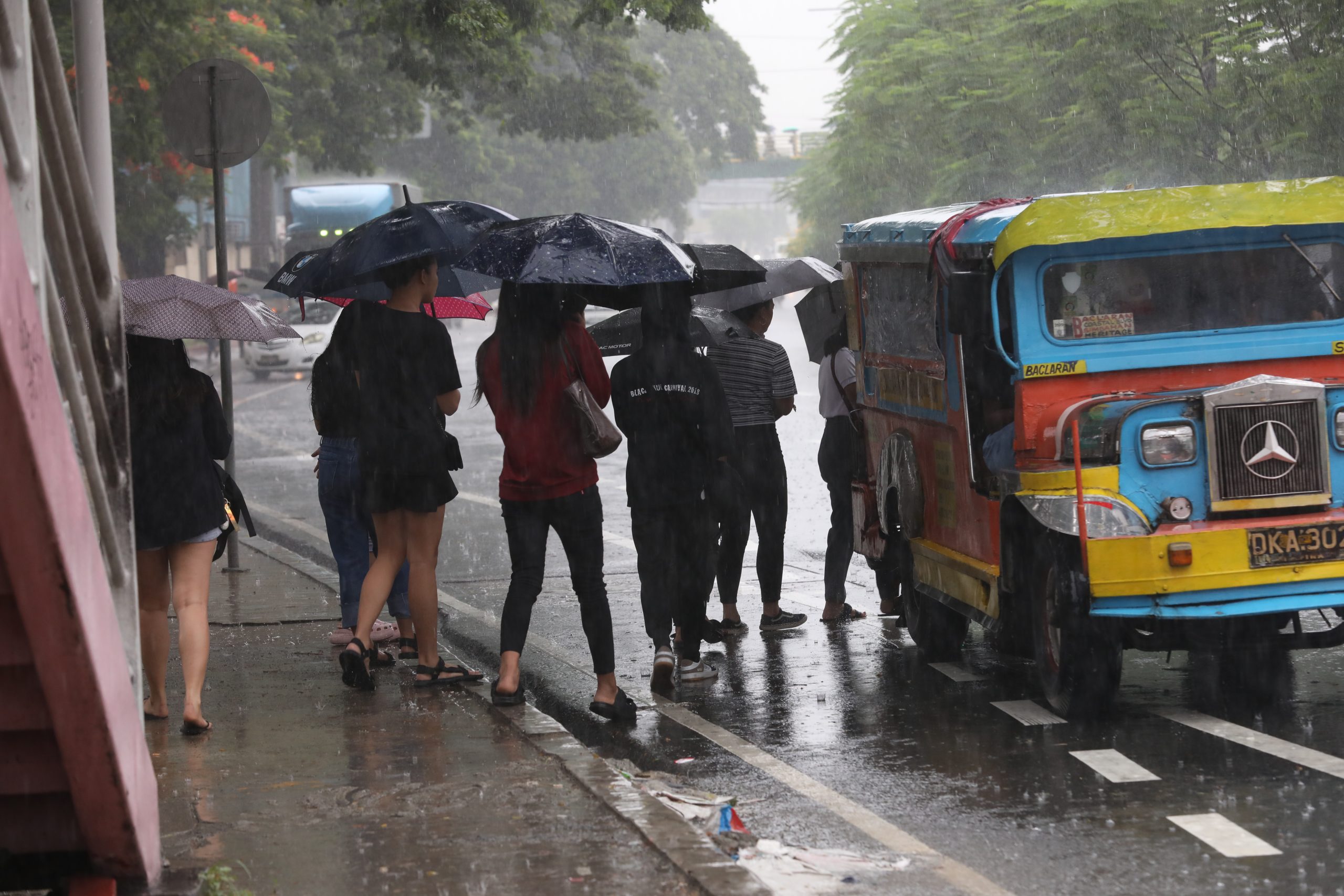 passengers riding jeep during rainy season