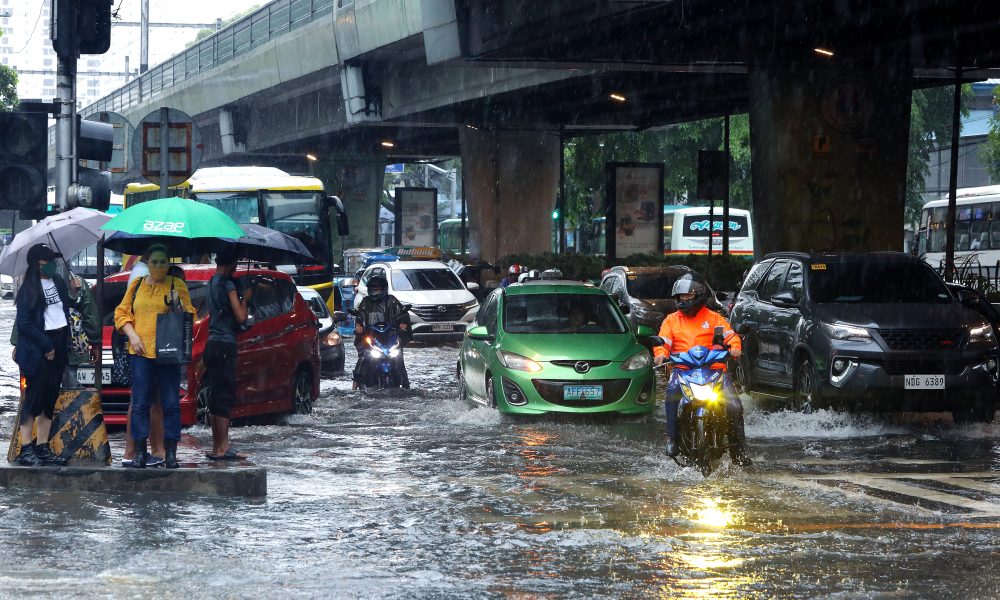 flooded street with cars and pedestrians