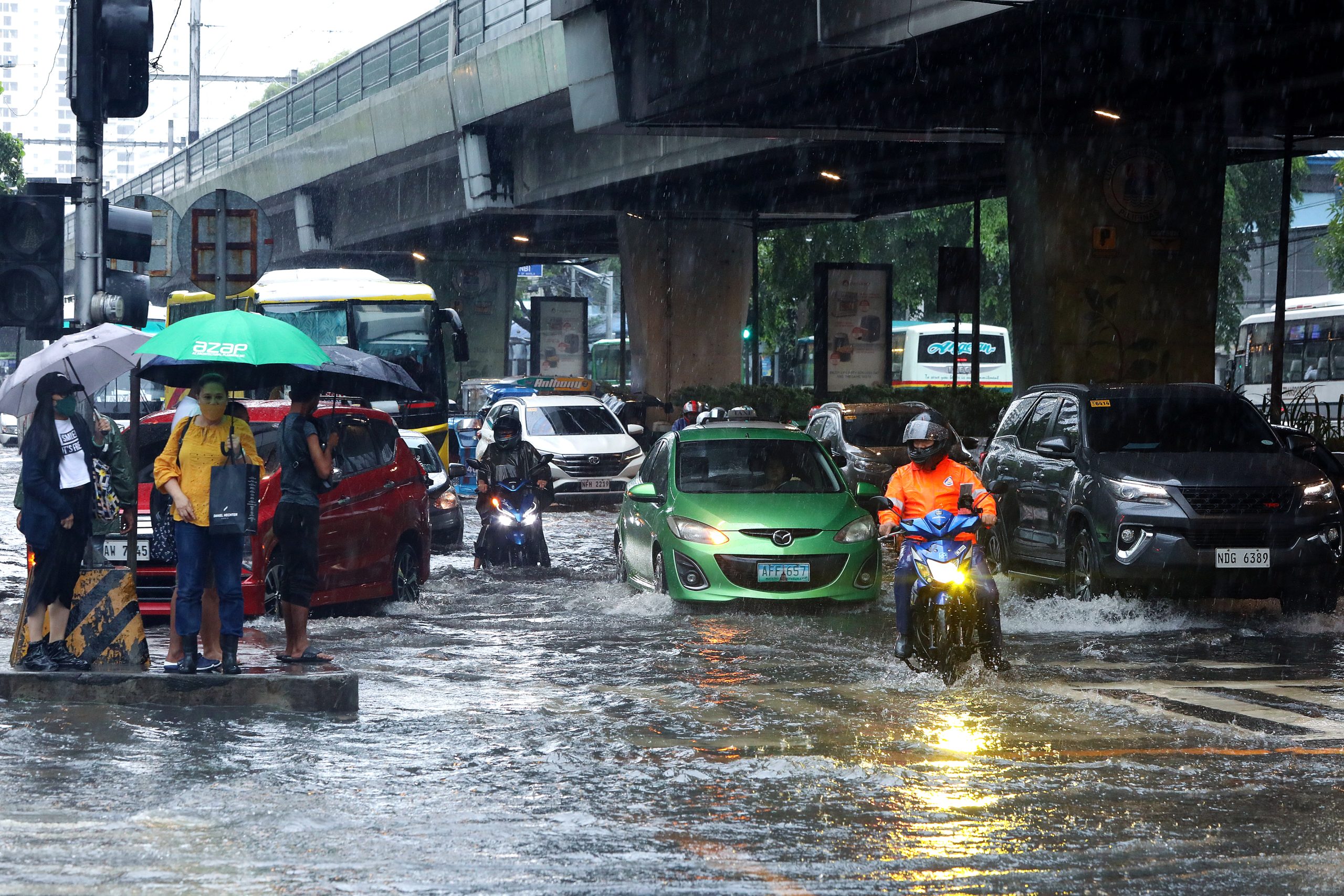 flooded street with cars and pedestrians