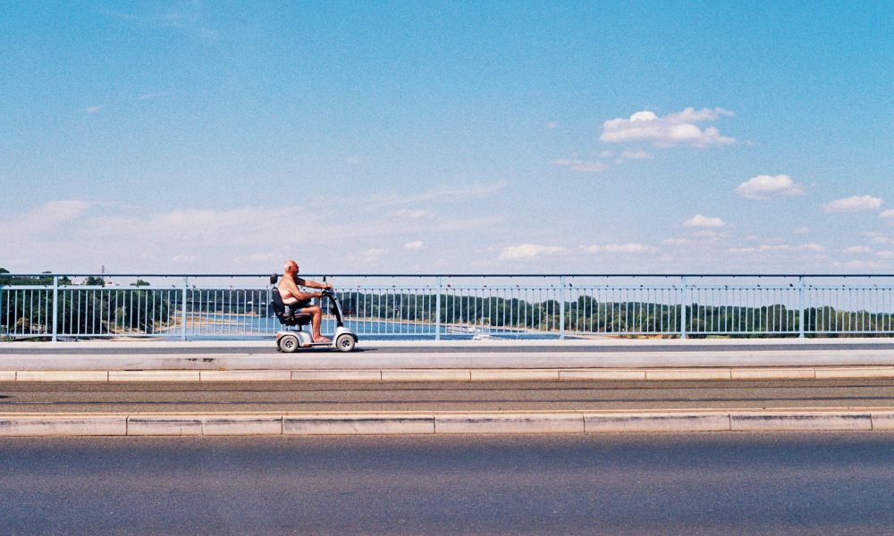 man driving along road