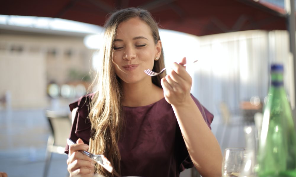 Woman in Purple Eating