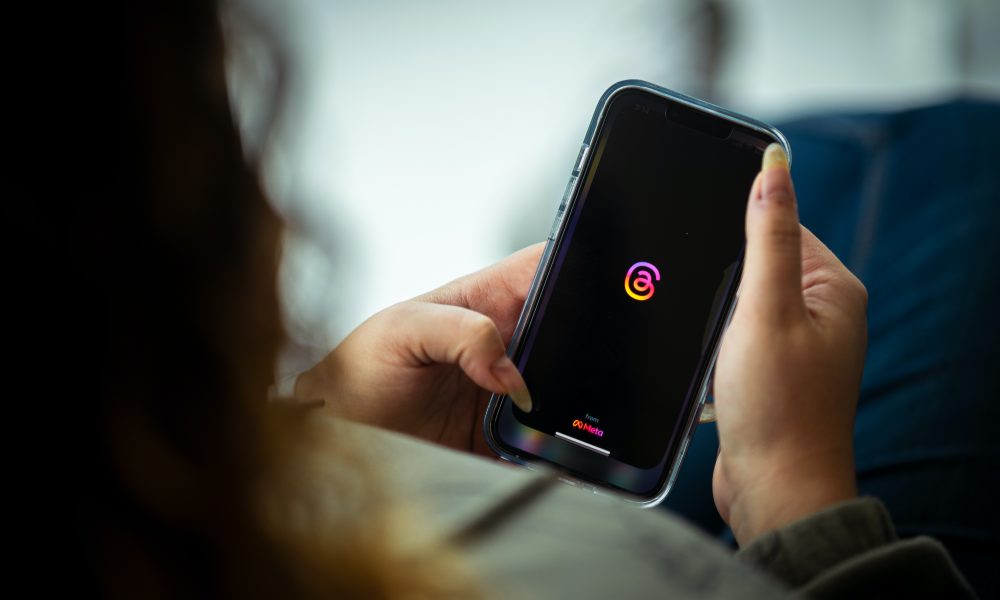 Woman Holding a Smart Phone and Looking at a Screen