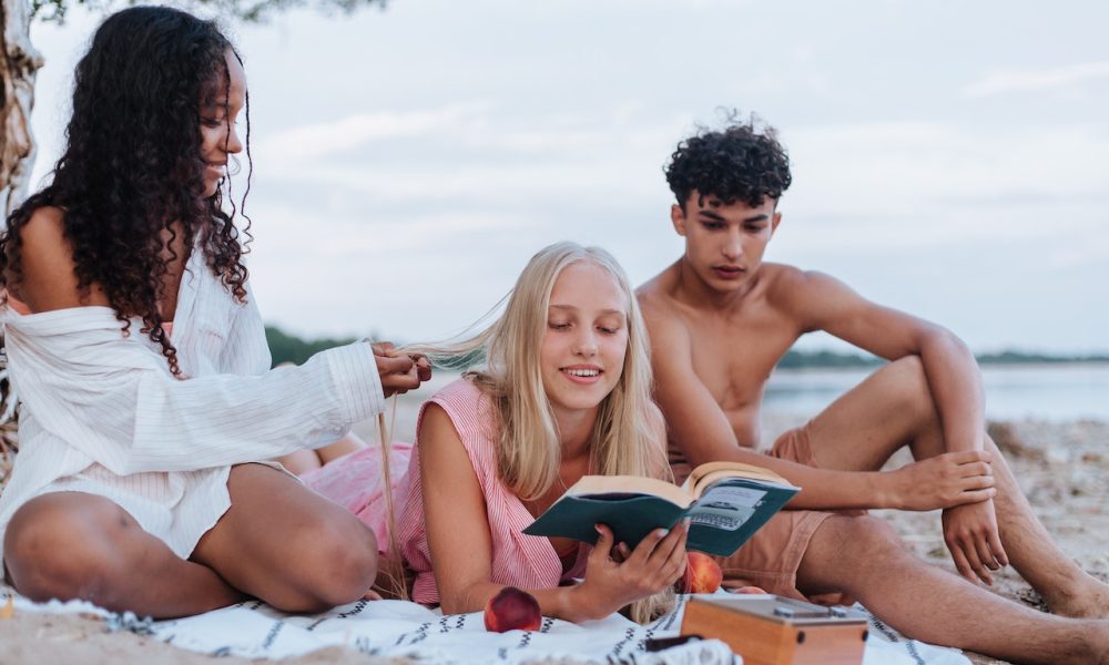 friends reading on beach