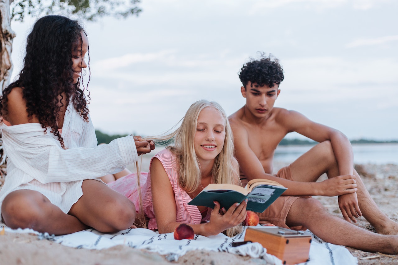 friends reading on beach