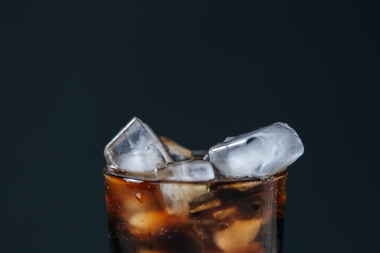 ice cubes and soft drink on glass