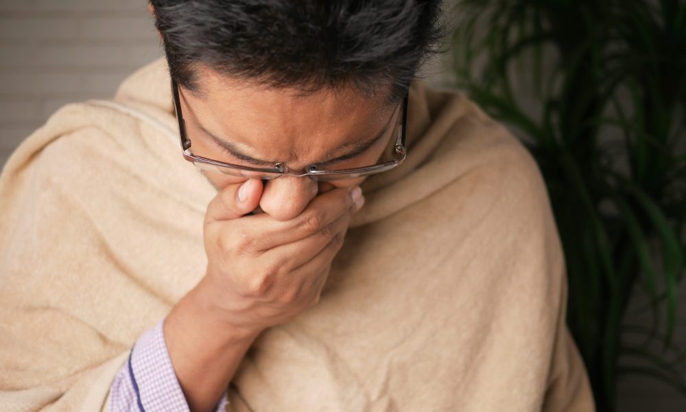 Man covering his mouth