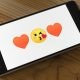 heart kissing emoji on phone screen