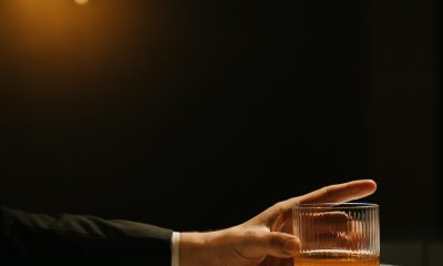 hand holding a glass of whisky
