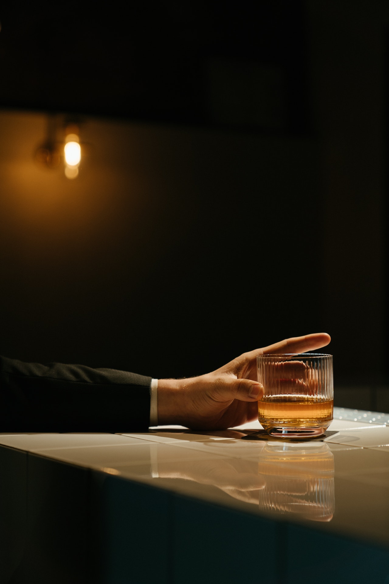 hand holding a glass of whisky
