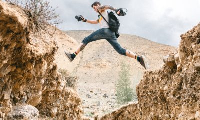 Active man jumping over rocky formations