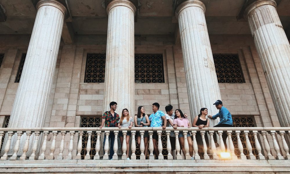 Photo of Couples Standing Near Railings