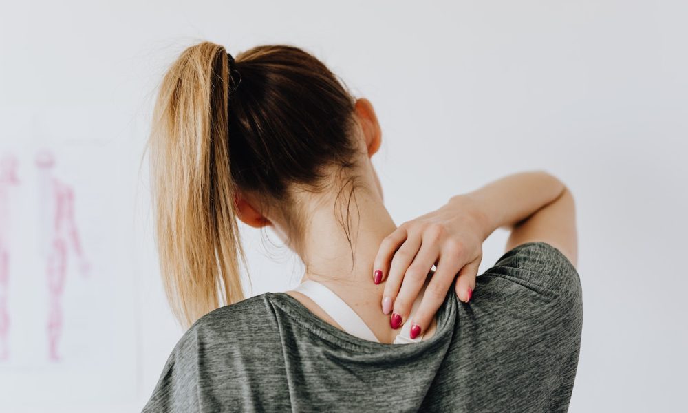 woman touching her back