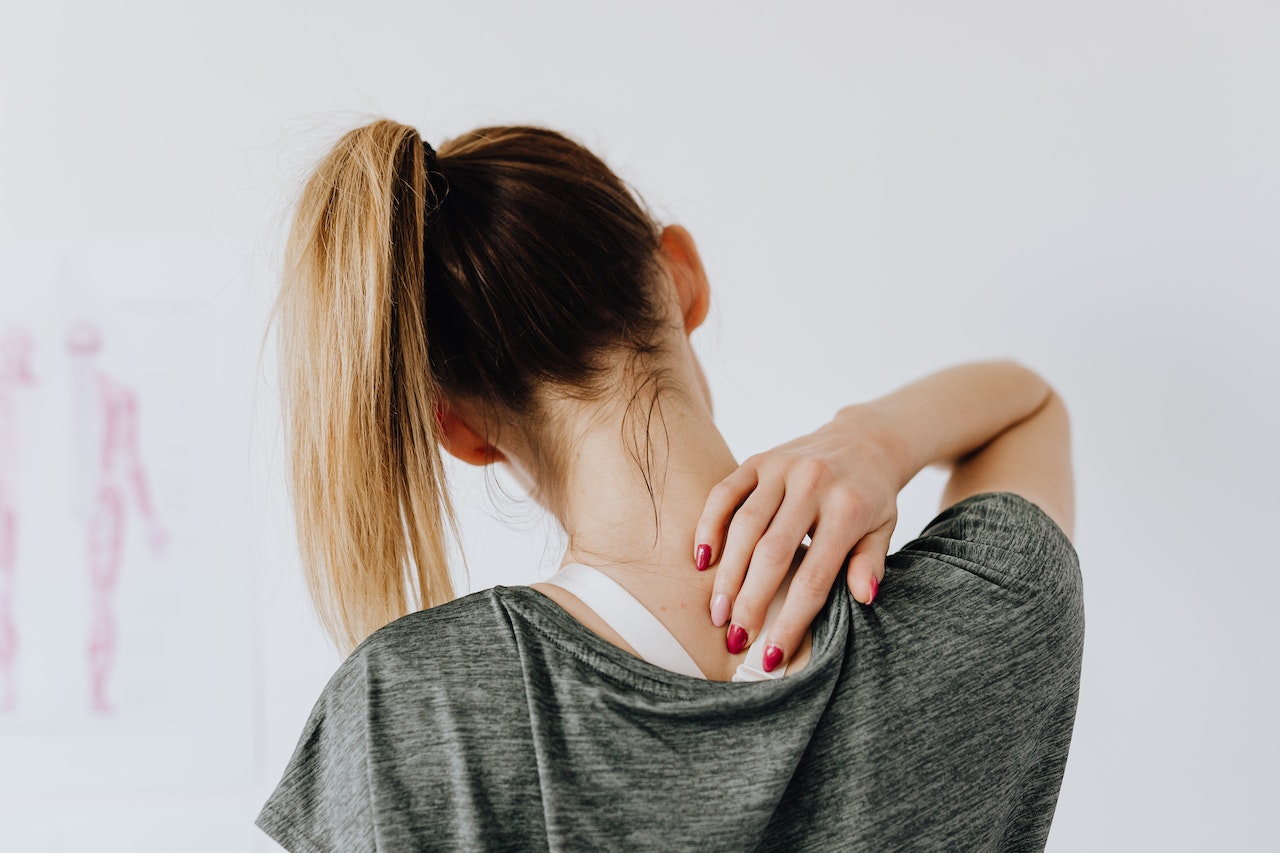 woman touching her back