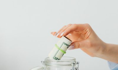 putting rolled bills on jar