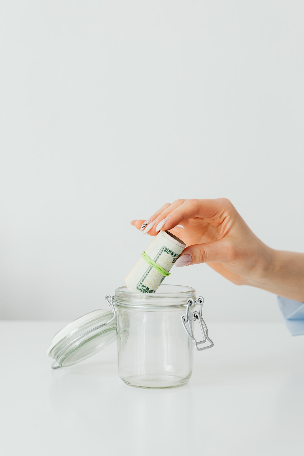 putting rolled bills on jar