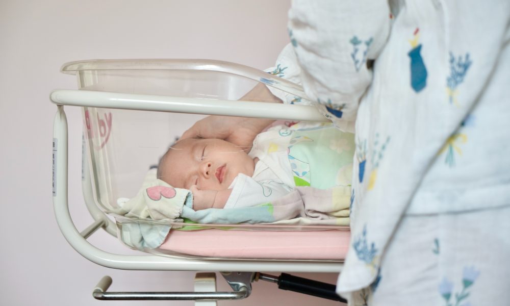 A Newborn Baby Sleeping in a Baby Cart
