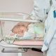 A Newborn Baby Sleeping in a Baby Cart
