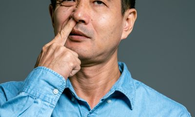 Man in Blue Top Picking Nose