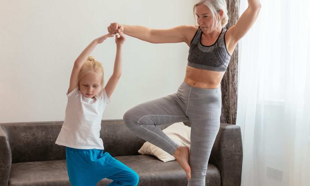 A Grandmother and Granddaughter Exercising at Home