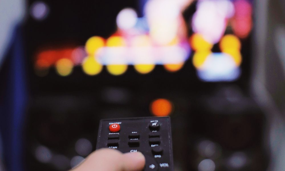 Anonymous person with TV remote