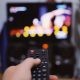Anonymous person with TV remote