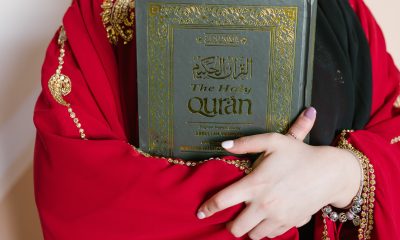 Person Holding A Holy Quran Book