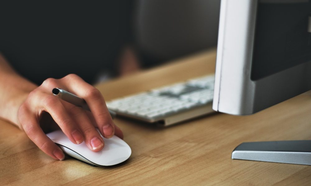 person holding mouse with keyboard