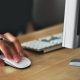 person holding mouse with keyboard