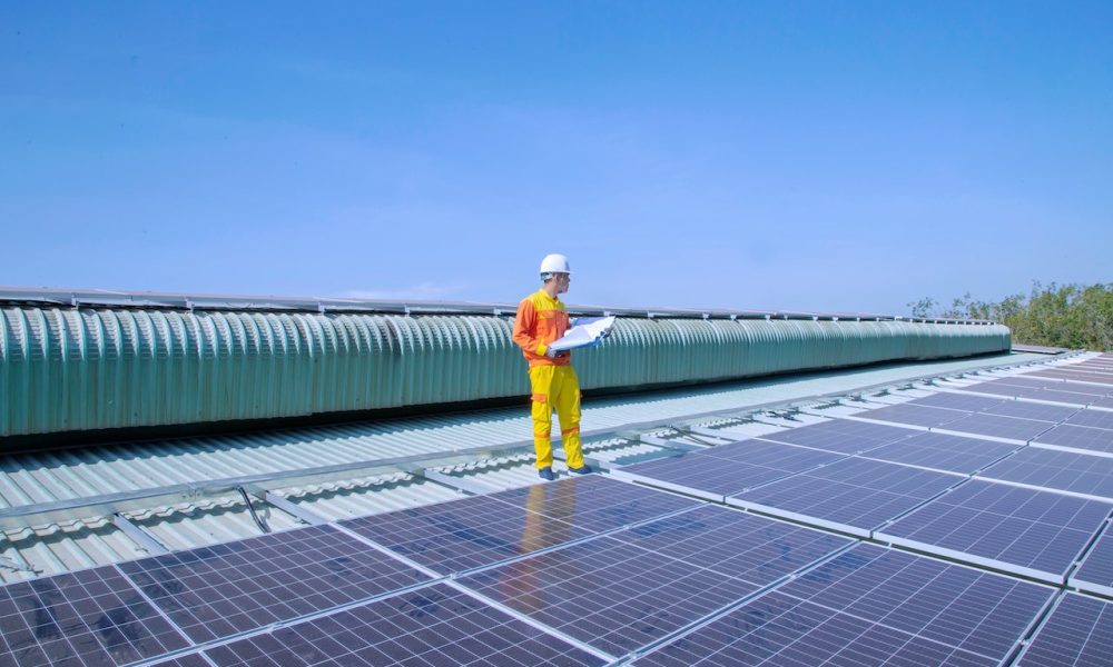 man standing on solar panels