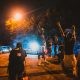 Black men standing on street near journalists and police car during anti racism demonstration