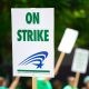 People Rallying Carrying on Strike Signage