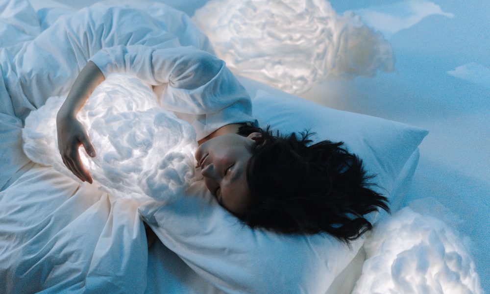 Photo of a Woman Sleeping Hugging a Cloud