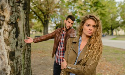 Woman And Man Wearing Brown Jackets Standing Near Tree