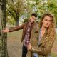 Woman And Man Wearing Brown Jackets Standing Near Tree